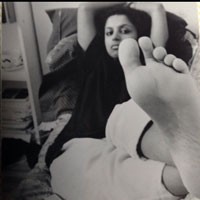 Author Photo of Devi S. Laskar lying on bed