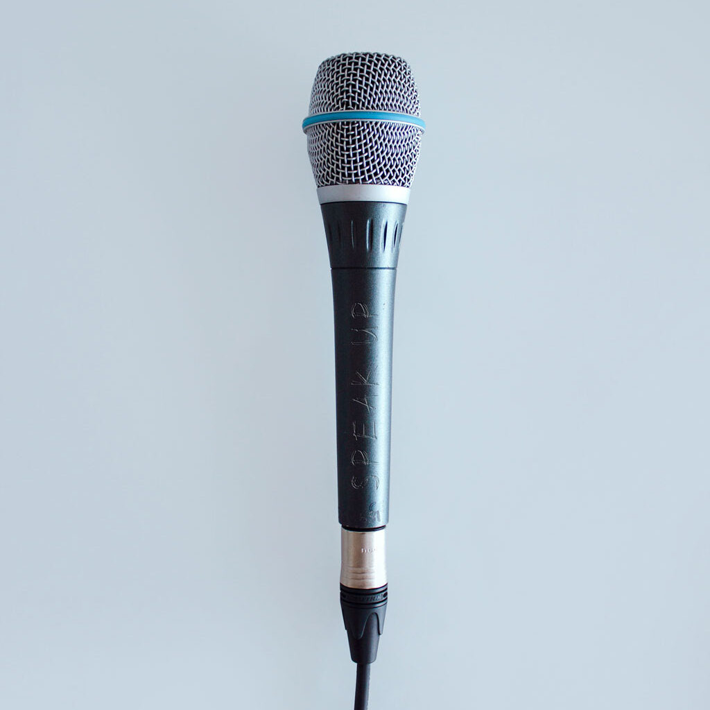 microphone with cord against pastel blue background