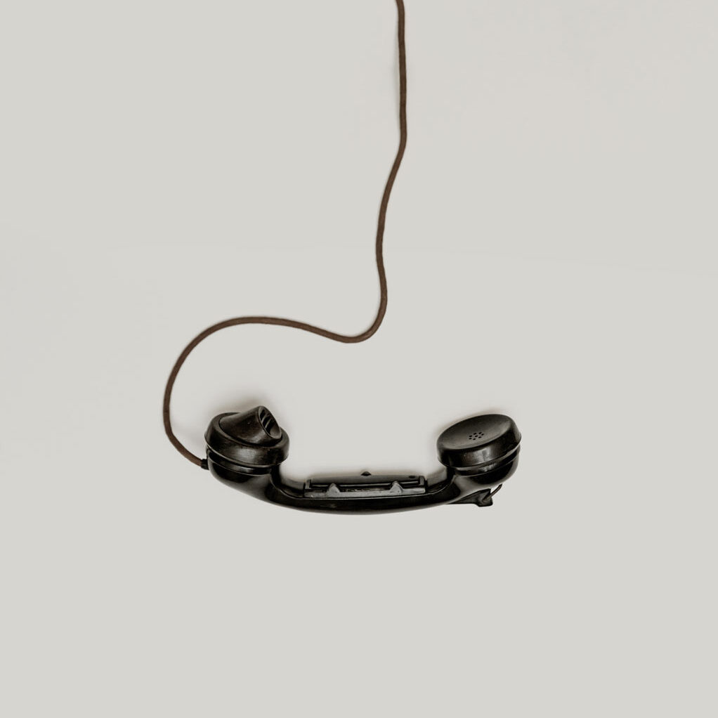 old-fashioned telephone receiver with coiled cord