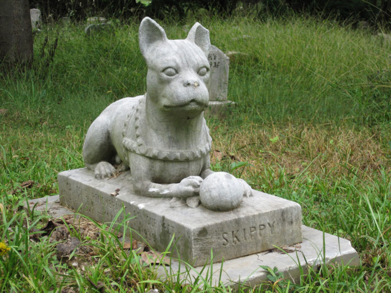 Dog's tombstone with a statue of a dog