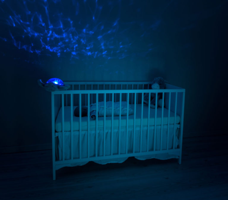 Baby crib in a darkened room