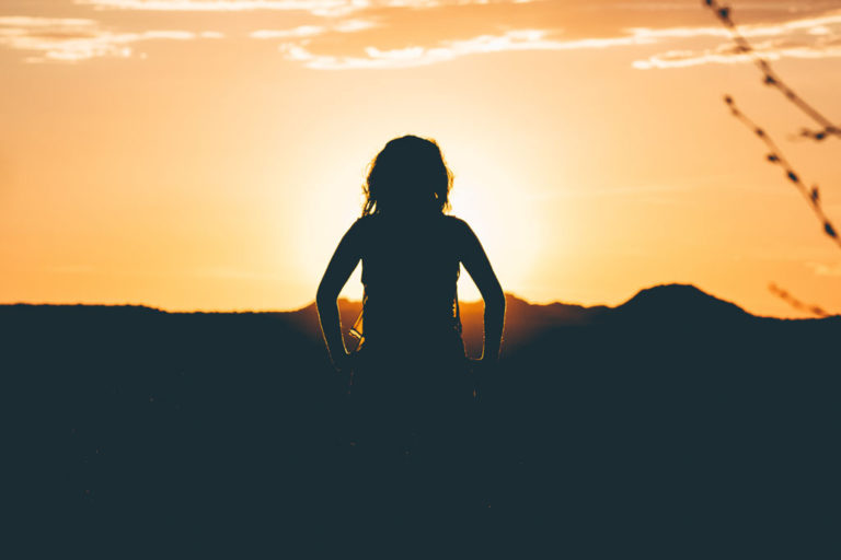 child facing into the sunset