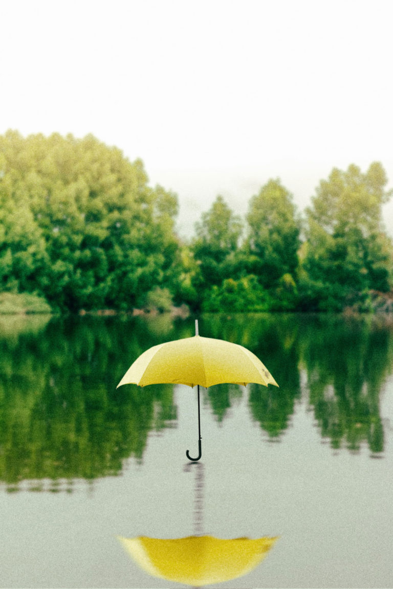 yellow umbrella hovering over a lake