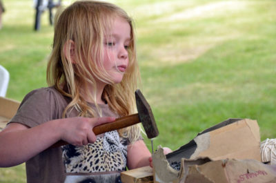 Little girl working with hammer