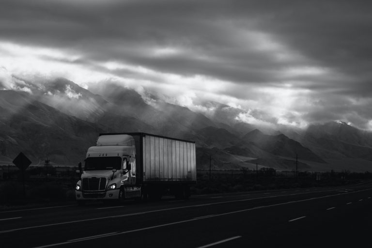 b/w photo of a truck on a highway